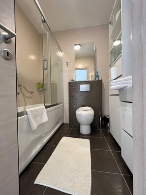 Bathtub, hair dryer, towels, soap