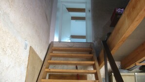 A wooden staircase leading to a door.