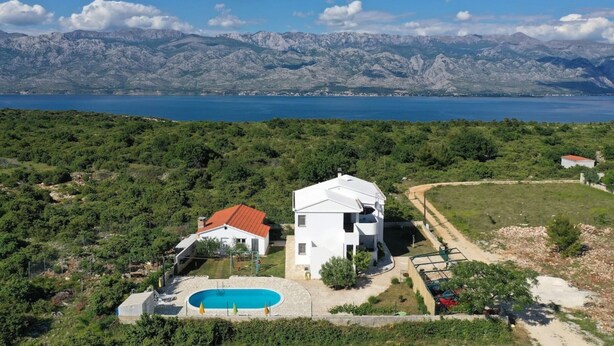 A white villa with a swimming pool, surrounded by lush greenery and mountains in the background. - Summer House Amon (Razanac)