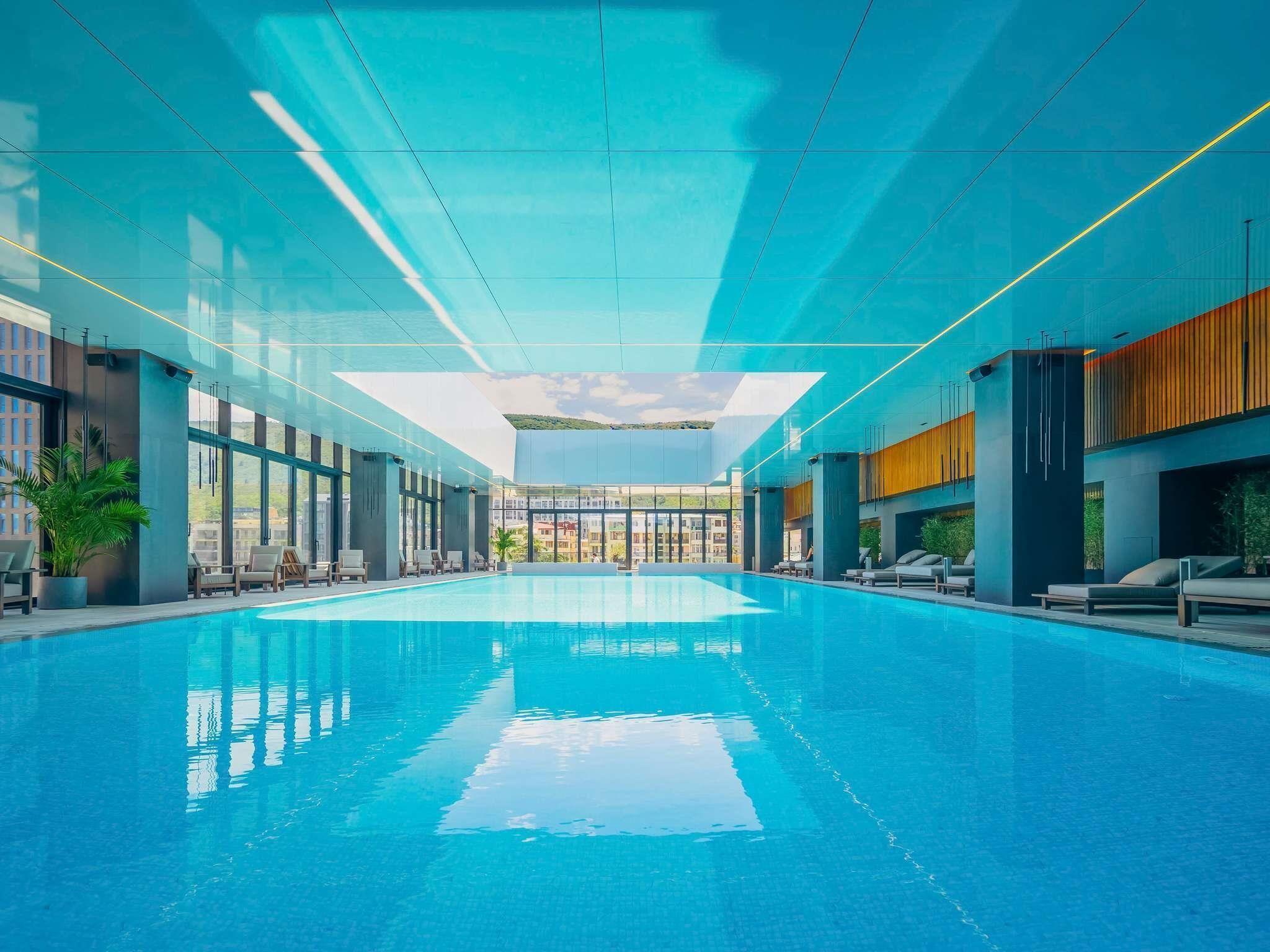 Indoor pool, pool umbrellas, sun loungers