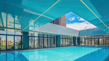 Indoor pool, pool umbrellas, pool loungers