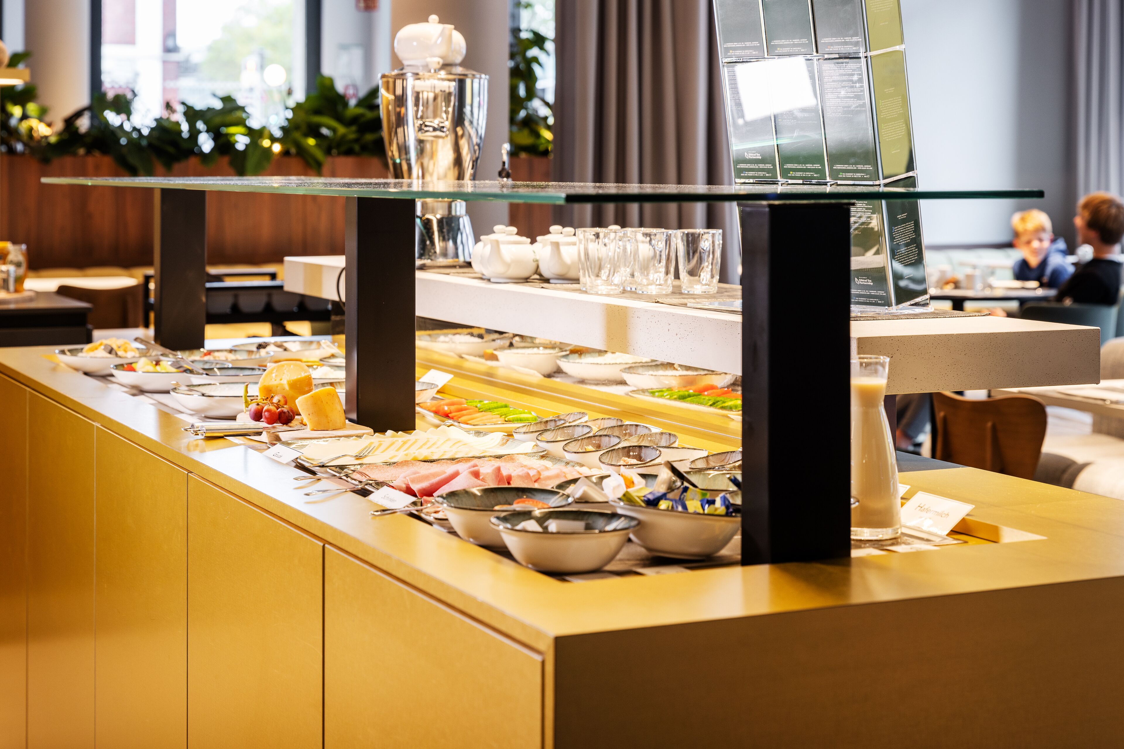 A buffet area with various food items and utensils.