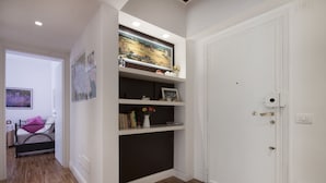 A room with a bed, a shelf with books and decorative items, and a door. - Roma-INCANTATA, Large balcony, Central, Next to the main Subway, Lively District (Roma)