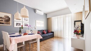 A modern living room with a dining area, featuring a sofa, dining table, and artwork on the walls. - Roma-INCANTATA, Large balcony, Central, Next to the main Subway, Lively District (Roma)