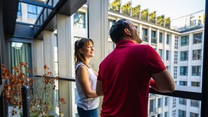 A man and a woman standing on a balcony with a view of a cityscape. - The People Paris Marais (Paris)