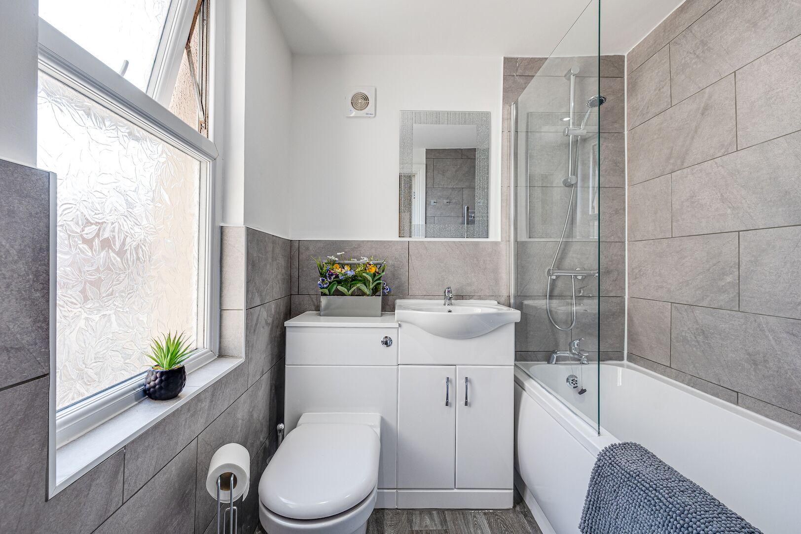 Bathtub, hair dryer, towels, toilet paper