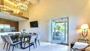 A modern kitchen with a dining area, a sofa, and a view of the outdoors. - VILLA CHIANTI ROSSO - Four Bedroom Villa, Sleeps 9 (Greve in Chianti)