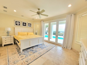 A bedroom with a bed, nightstands, a ceiling fan, and a view of a pool. - Front Row Beach House 6BR/5.5 bath private pool and private beach access. (Miramar Beach)