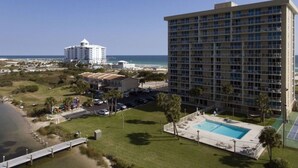 A hotel with a pool, a beach view, and a parking area. - Wake up with a view in a beautiful condo (Pensacola Beach)