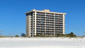 A multi-story hotel with a flat roof, located near a beach. - Wake up with a view in a beautiful condo (Pensacola Beach)