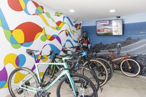 A bicycle rental station with a colorful mural and a sign for a mountain biking tour. - MYND Yaiza (Yaiza)