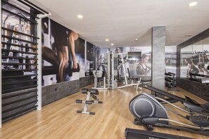 A gym with exercise equipment, wooden flooring, and a large mirror. - MYND Yaiza (Yaiza)