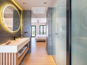 A modern bathroom with a vanity, a large mirror, and a shower area. - MYND Yaiza (Yaiza)
