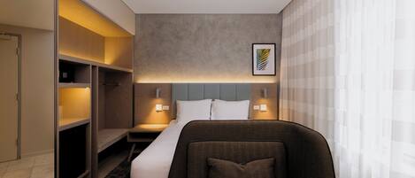A hotel room with a bed, bedside tables, a wardrobe, and a framed picture on the wall.