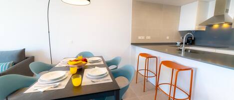 A modern kitchen with a dining area.