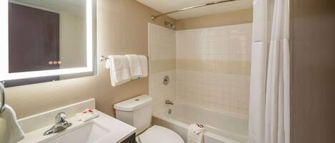 A bathroom with a sink, toilet, and bathtub.