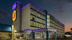 A multi-story hotel with a prominent 'Baymont by Wyndham' sign, a 'Super 8' logo, and a 'Clearance F' entrance. - Baymont by Wyndham Laredo (Laredo)