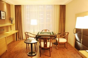 A hotel room with a pool table, a sofa, and a dining table with chairs. - Hui Nan Hotel (Huinan)