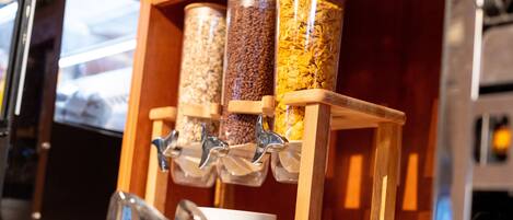 A wooden dispenser with multiple containers holding different grains.