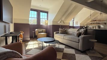 Deluxe Penthouse | Living area | 50-inch Smart TV with digital channels, Netflix, books