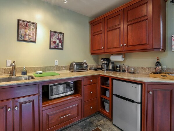 Fridge, microwave, coffee/tea maker, cookware/dishes/utensils