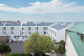 Stunning views of the sky and distant horizon from this residential building's spacious balconies and large windows.
