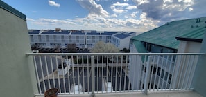 Enjoy the view from this balcony overlooking the parking area and building complex.