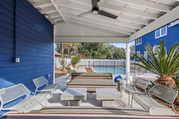 An outdoor patio with a pool, seating, and a covered area. - A Port in the Storm - Shangri La, Poolside Estate in Isle of Armstrong (Thunderbolt)