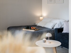A neatly arranged bedroom with a bed, bedside table, lamp, and a tray with cups and fruits. - Apartments Tomy - Studio Apartment with terrace (Sutivan)