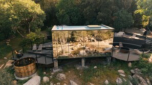 A modern outdoor cabin with a glass enclosure, wooden deck, and a fire pit. - Paradise Ranch Inn Stellar House Hot-Tub,Sauna . (three rivers)