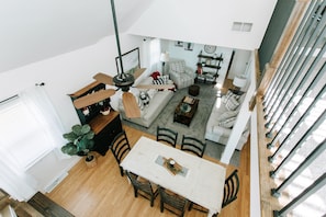 A spacious loft apartment with a dining area, living room, and kitchen.