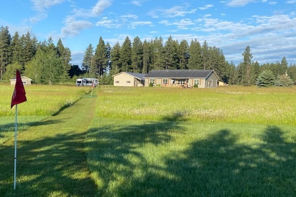 Back of yard facing west towards apt