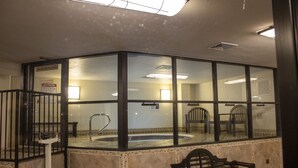 A room with a glass partition, a bench, and a tiled floor.