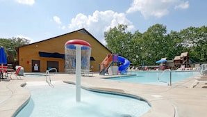 A swimming pool area with a water fountain, a slide, and lounge chairs. - 6BR Branson Lodge | 6 King Rooms | Near Silver Dollar City + Pools (FHL-263WO) (Branson)