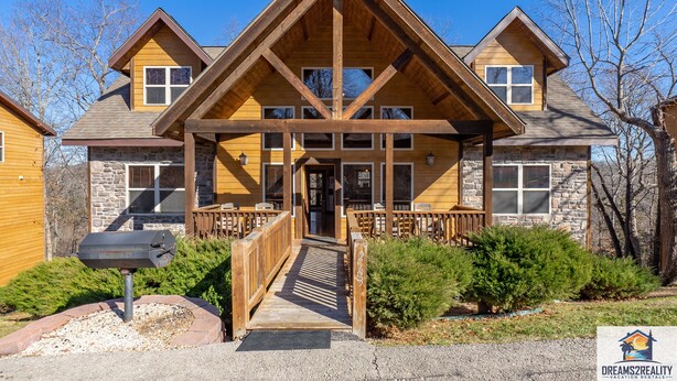A lodge with a stone facade, wooden beams, and a covered entrance. - 6BR Branson Lodge | 6 King Rooms | Near Silver Dollar City + Pools (FHL-263WO) (Branson)