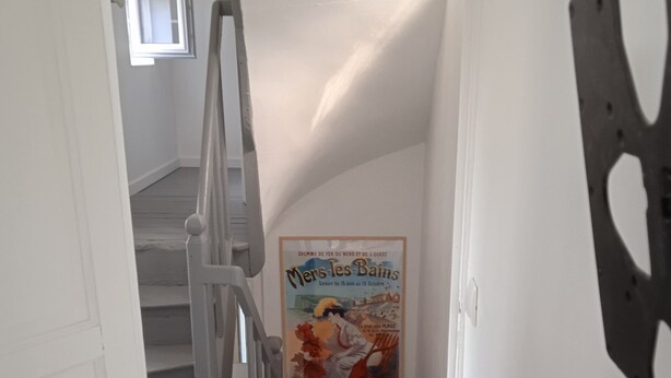 A staircase with a poster advertising 'Mers-les-Bains' season from June 15 to October 15. - Charming Mersoise house 7 minutes walk from the beach with private covered parking (Mers-les-Bains)