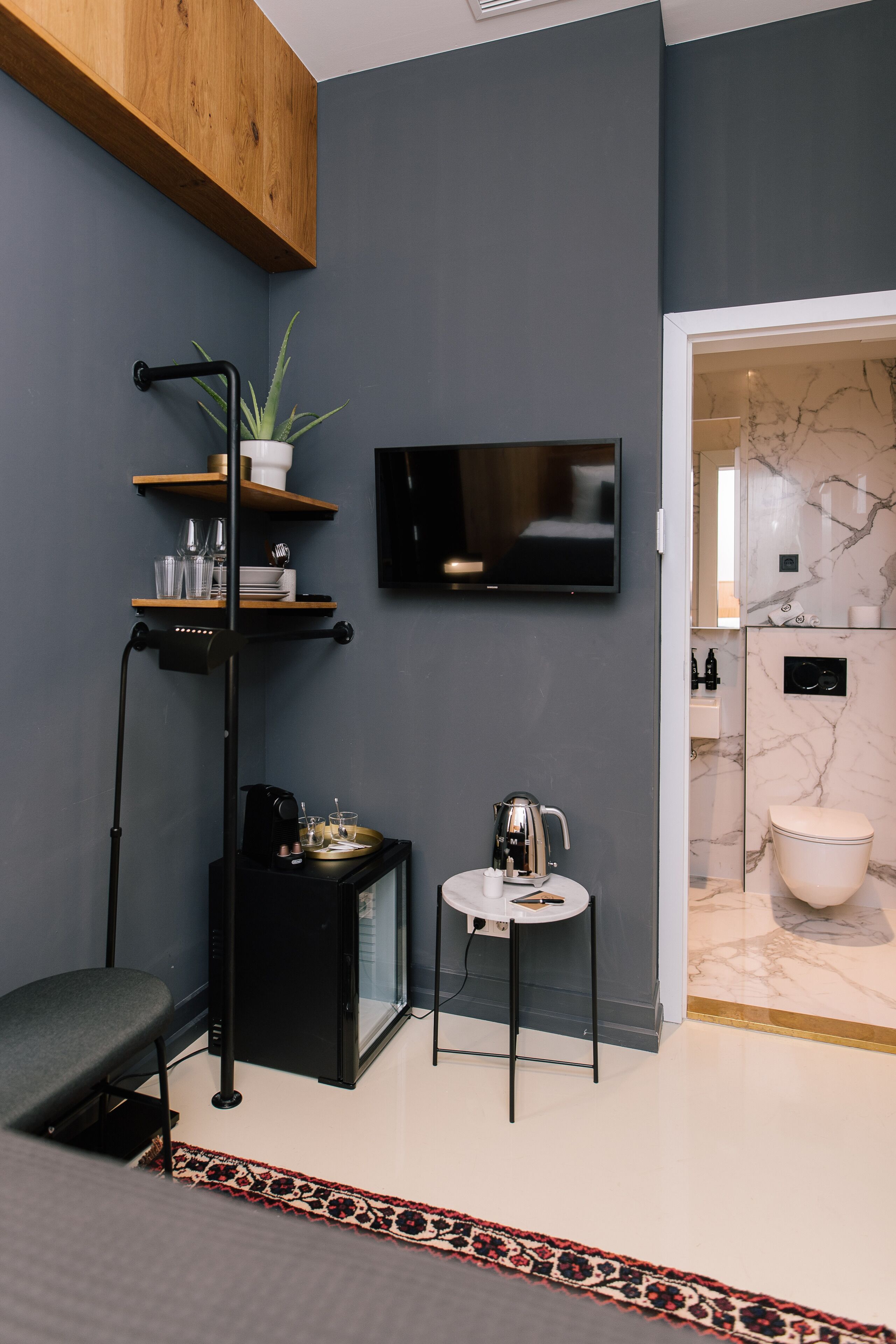 A modern bathroom with a marble vanity, a toilet, and a shower area.