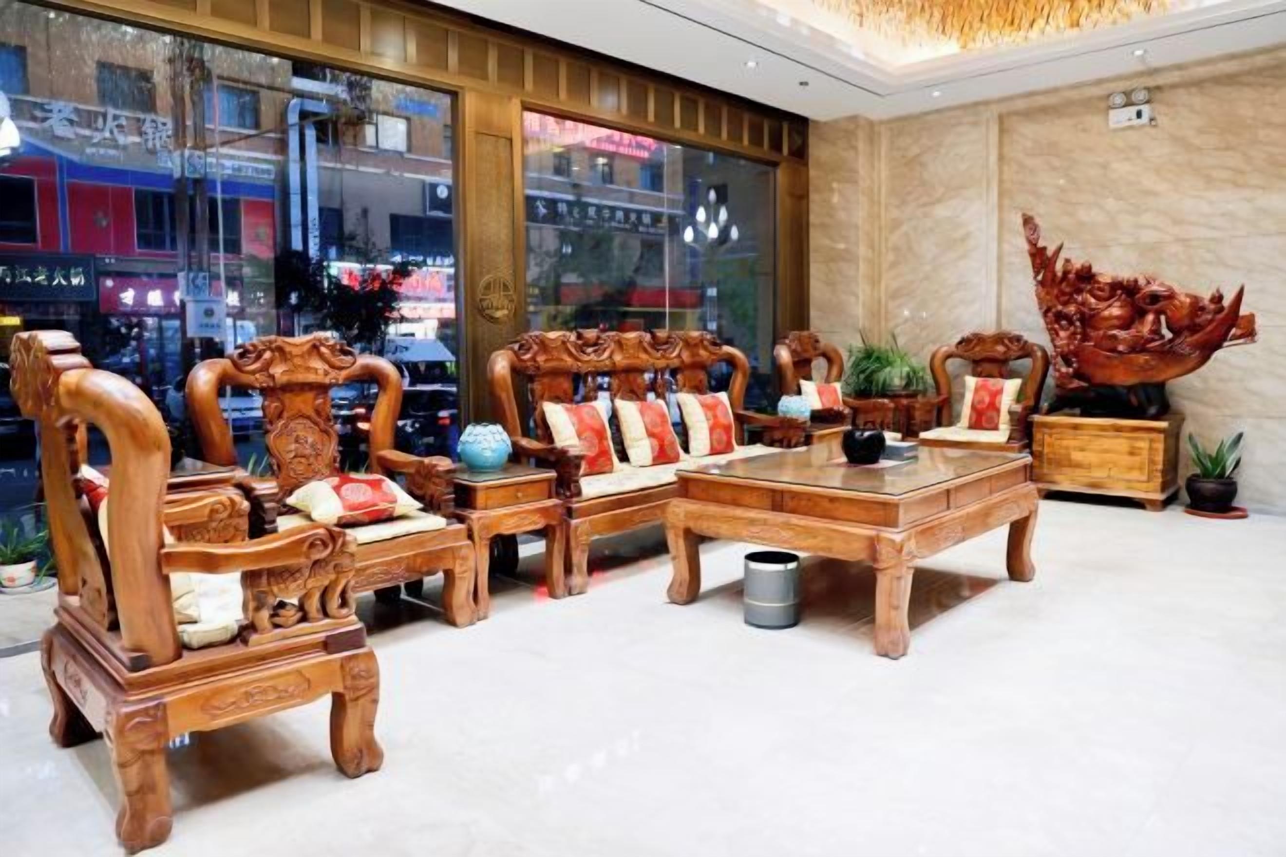A traditional wooden furniture set with a coffee table, two armchairs, and a sofa.