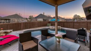 A backyard with a swimming pool, outdoor furniture, and a barbecue grill. - Lxry 4 BR, Heated Pool/Spa, Large Game Room, near Seaworld/Six Flags (St1) (San Antonio)