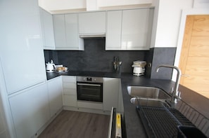Enjoy cooking in this well-equipped kitchen with an oven and stainless steel sink.