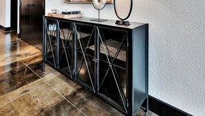 A modern hallway with a black console table, a white lamp, and a large abstract painting on the wall. - Crusader Bear Hut- Downtown Waco- Steps To The Silos (Waco)
