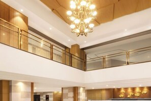 A multi-level hotel interior with a grand chandelier, wooden paneling, and a modern design. - Braim Seasons Hotel (Nanchang)