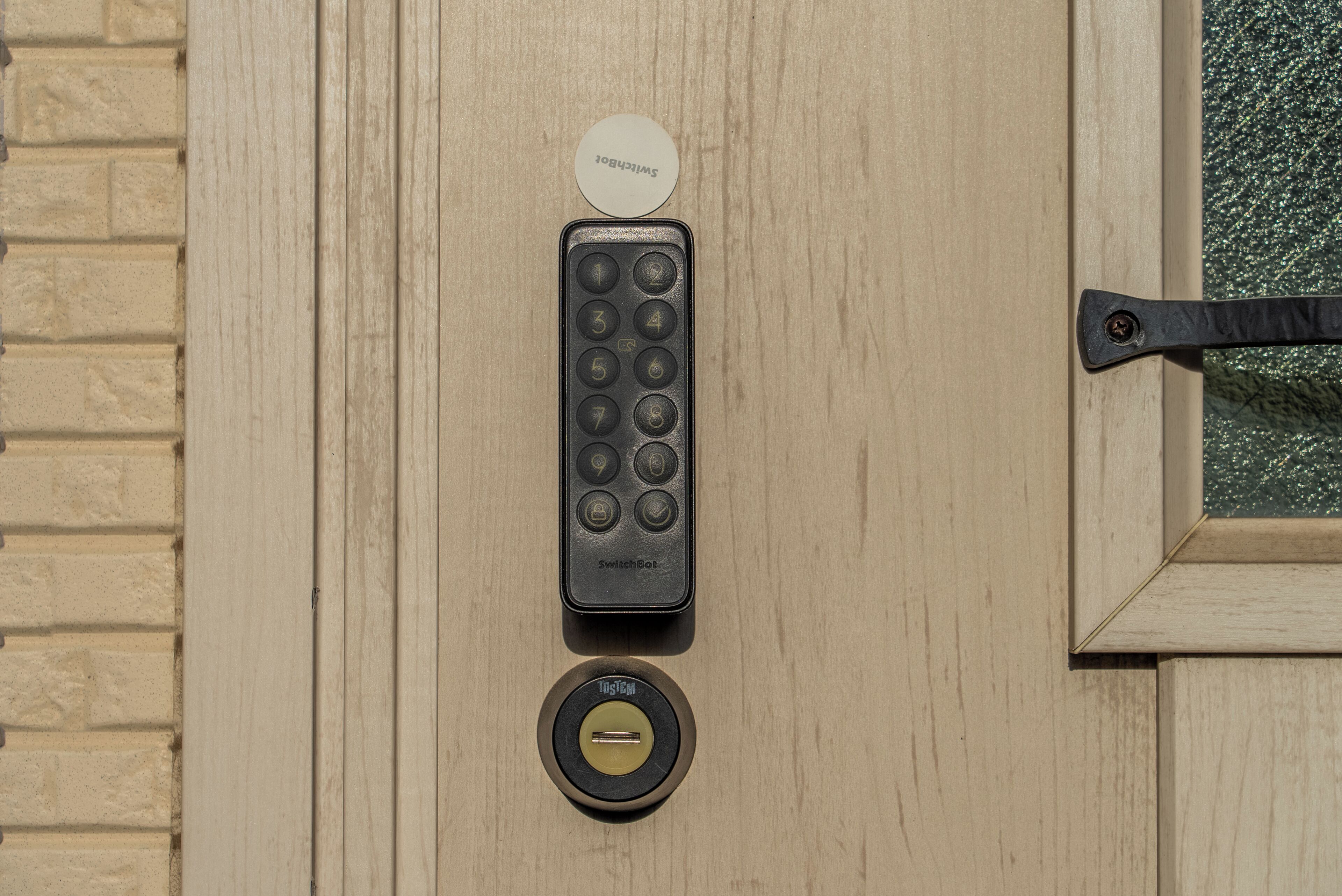 A door with a keypad lock, a keyhole, and a keycard reader.