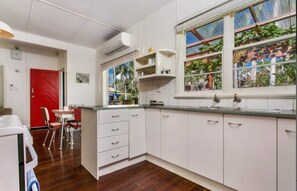Kitchen area with a window offering a view of the surrounding greenery.