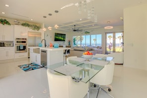 Enjoy cooking in this well-lit kitchen with a large island and ocean views.