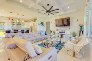 Relax in a spacious living area with a large L-shaped sofa, armchair, and stylish chair.
