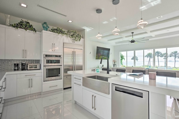 Enjoy cooking in this well-equipped kitchen with a large island, sink, and dining area.