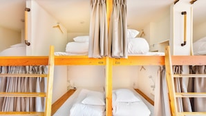 A bunk bed room with wooden frames, white bedding, and curtains. - Hostel Ogk (Osaka)