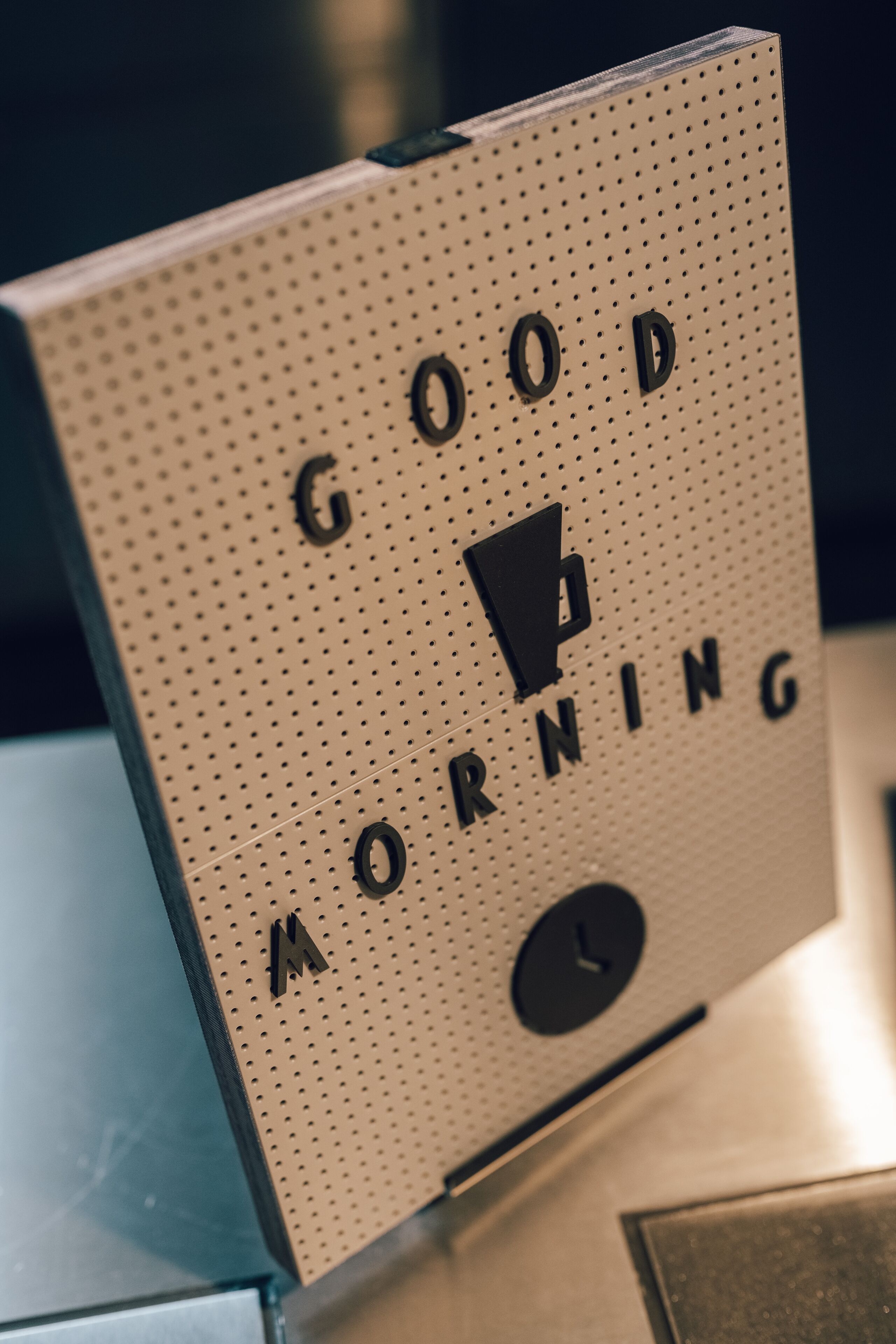 A wall-mounted sign with the words "GOOD MORNING" and a clock.