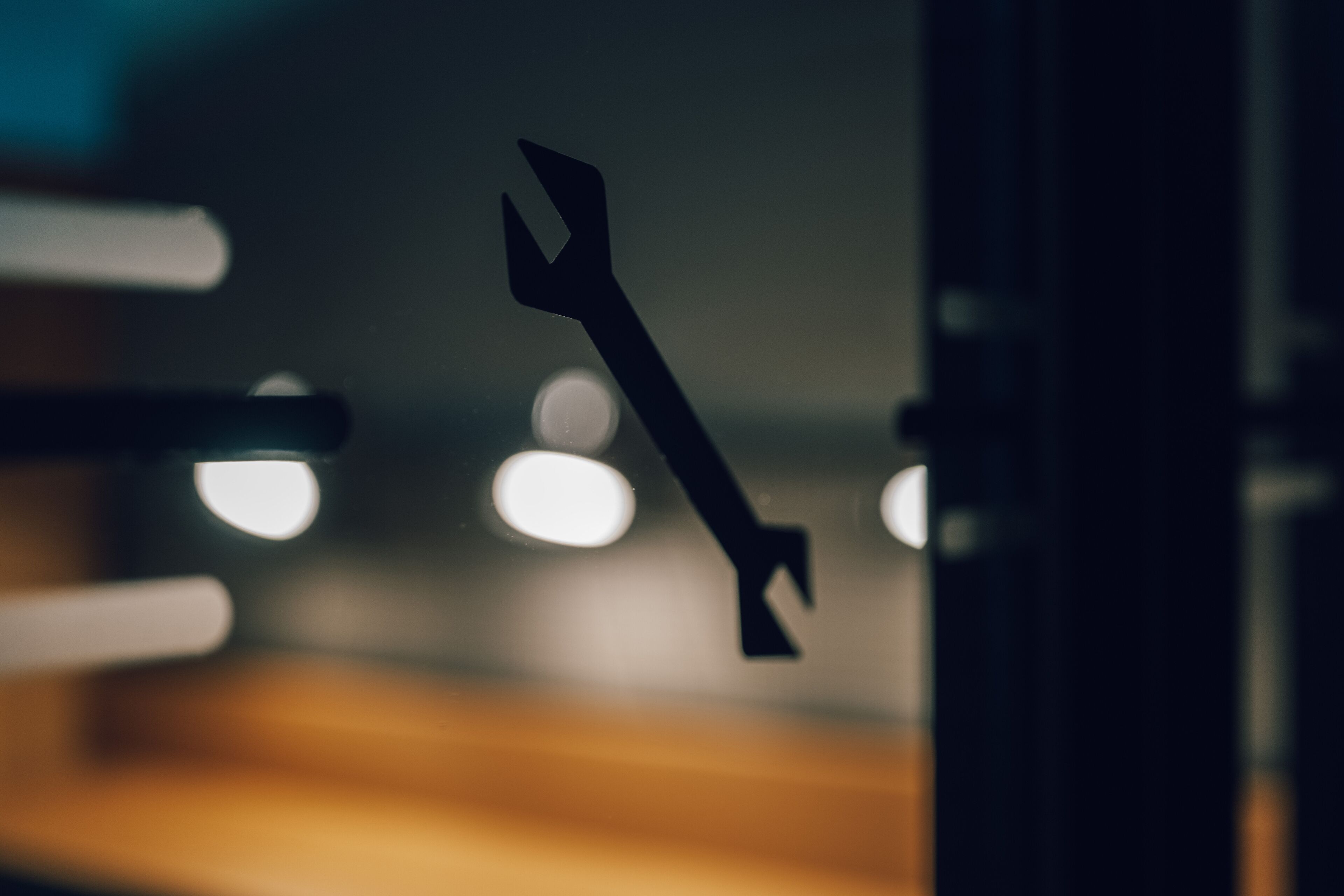 A wrench hanging on a metal structure.